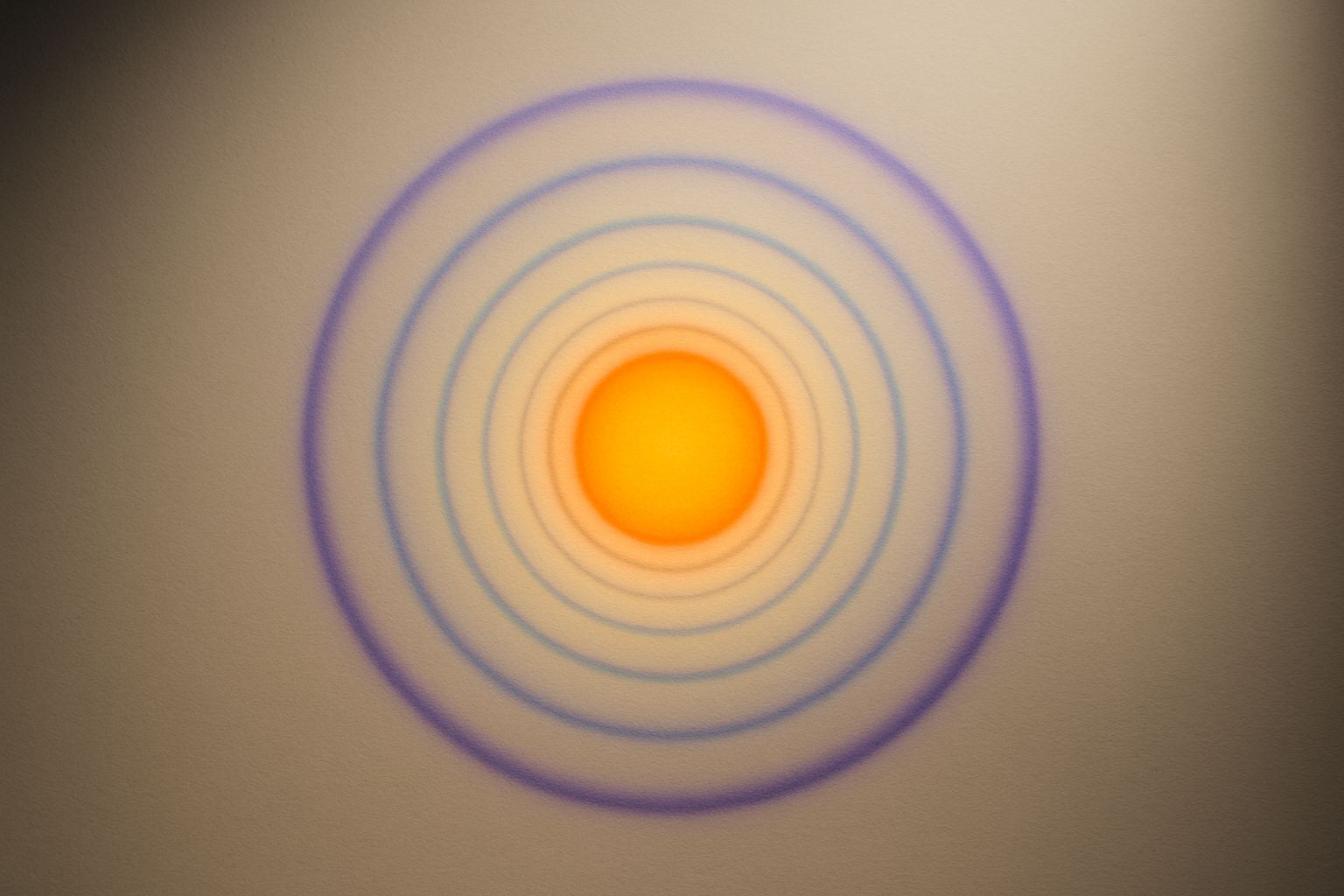 Diffraction rings. Equal steps in one quantity are not equal steps in another.